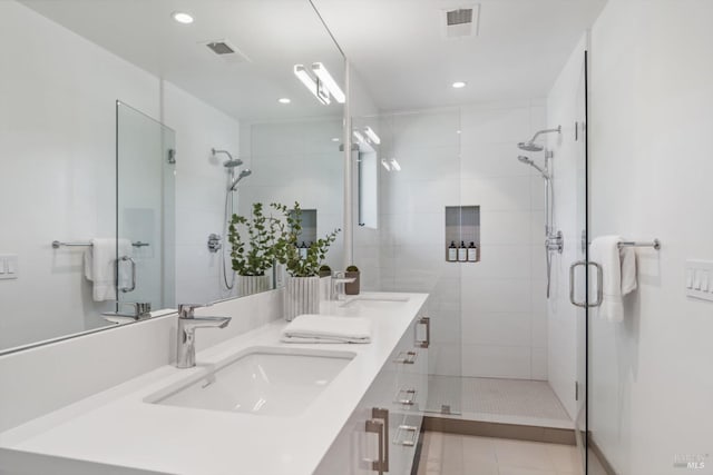 full bath featuring a sink, visible vents, and a shower stall