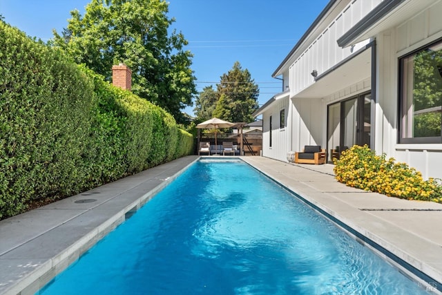 view of pool with a patio, a fenced backyard, and a fenced in pool