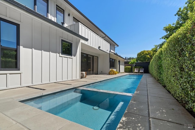 view of pool with a patio area, a fenced backyard, and a pool with connected hot tub