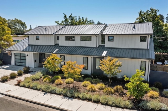 modern farmhouse style home featuring metal roof, a standing seam roof, and board and batten siding