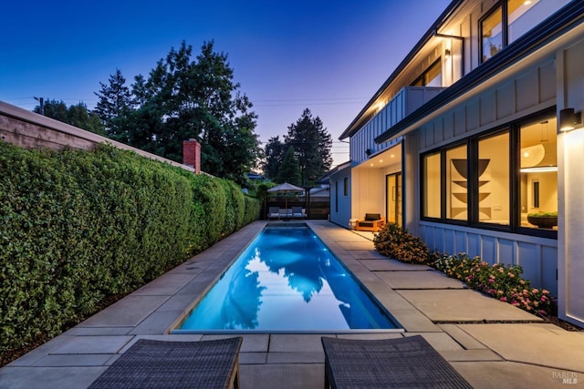 view of swimming pool featuring a patio area, a fenced backyard, and a fenced in pool