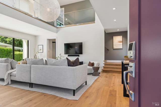 living area with stairway, recessed lighting, and light wood-style flooring