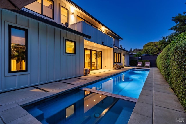 view of swimming pool featuring a patio area, a fenced backyard, and a pool with connected hot tub