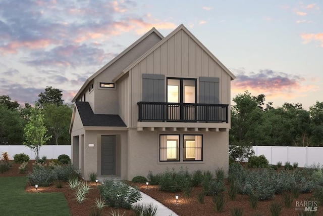 view of front of home with a balcony and a garage