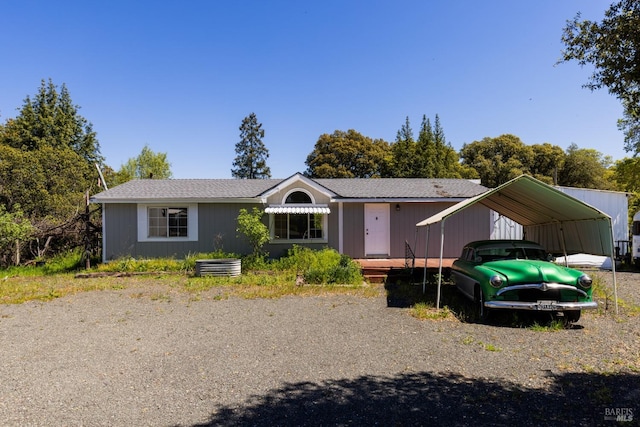 single story home featuring a carport