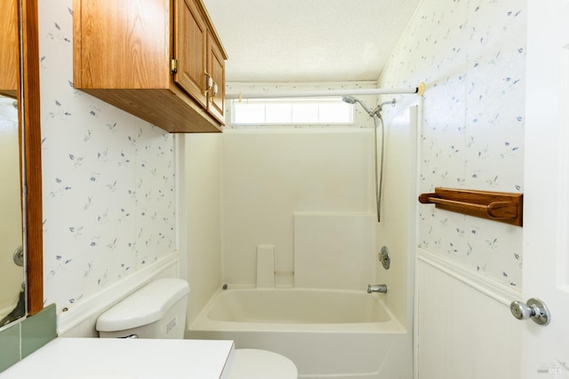 full bathroom featuring vanity, toilet, shower / bath combination, and a textured ceiling