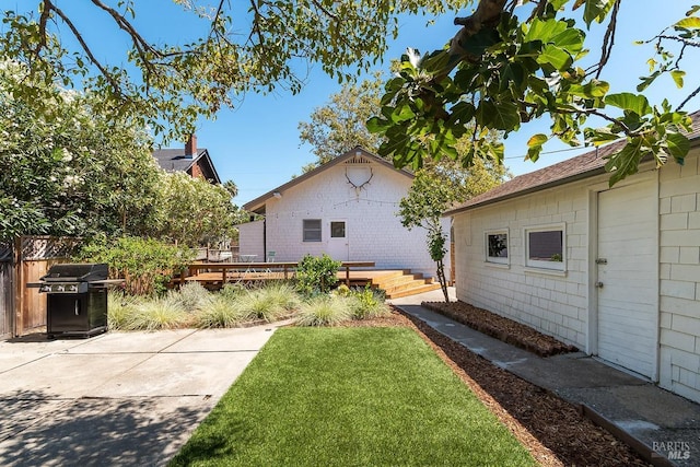 view of yard with a patio area and a wooden deck