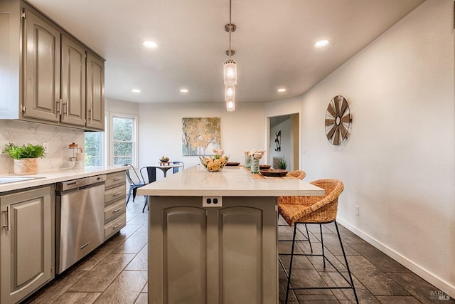 kitchen with a kitchen island, light countertops, dishwasher, and a breakfast bar area