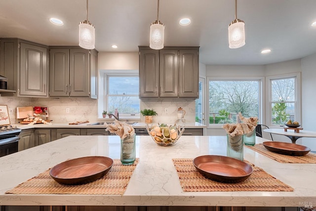 kitchen featuring hanging light fixtures, gray cabinets, and decorative backsplash