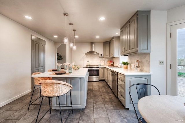 kitchen with wall chimney exhaust hood, appliances with stainless steel finishes, backsplash, and gray cabinets