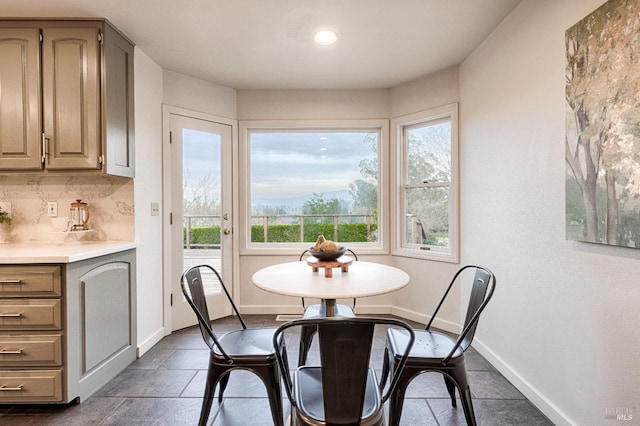 dining area featuring baseboards, recessed lighting, and a healthy amount of sunlight