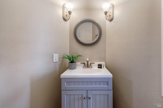 bathroom featuring a textured wall and vanity