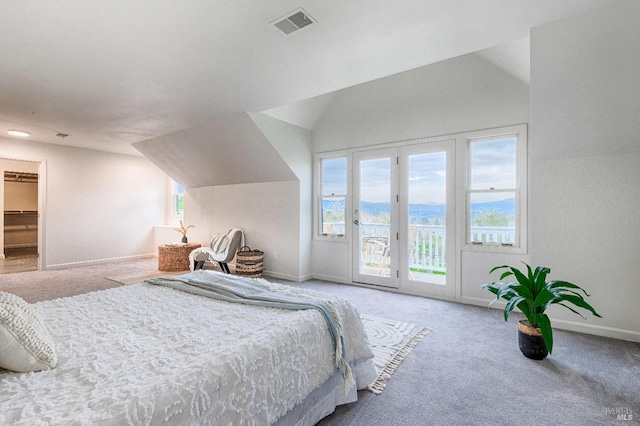 carpeted bedroom with access to exterior, multiple windows, vaulted ceiling, and visible vents