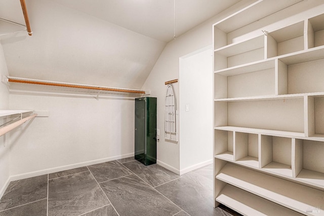 walk in closet featuring lofted ceiling