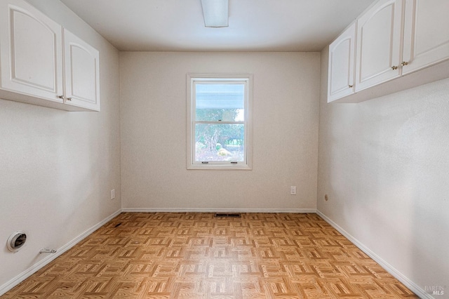 empty room with visible vents and baseboards