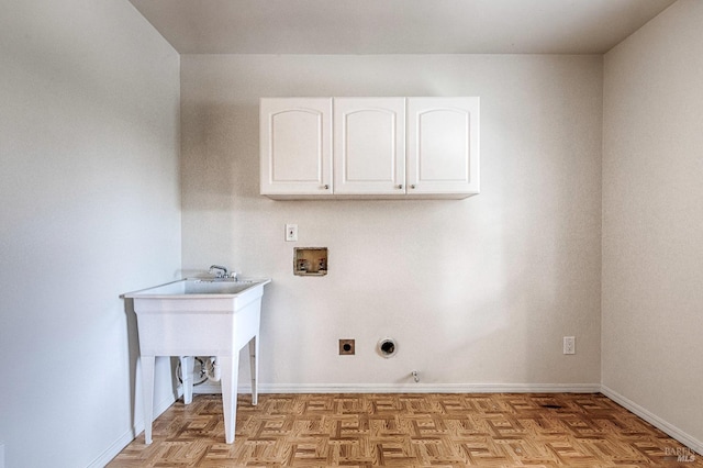 washroom featuring cabinet space, baseboards, washer hookup, and electric dryer hookup