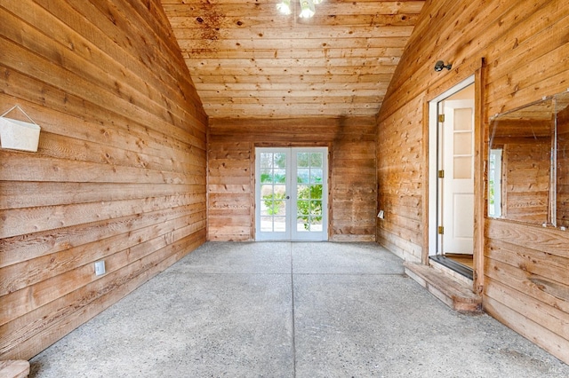 spare room with wood ceiling, lofted ceiling, french doors, and wood walls