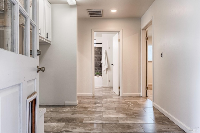 corridor with recessed lighting, visible vents, and baseboards