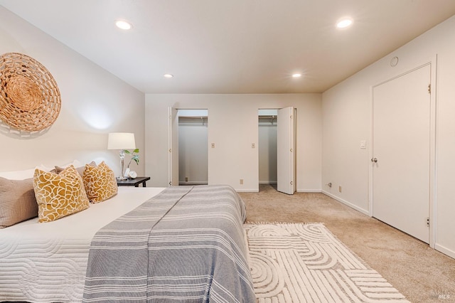 bedroom featuring multiple closets, recessed lighting, carpet flooring, and baseboards