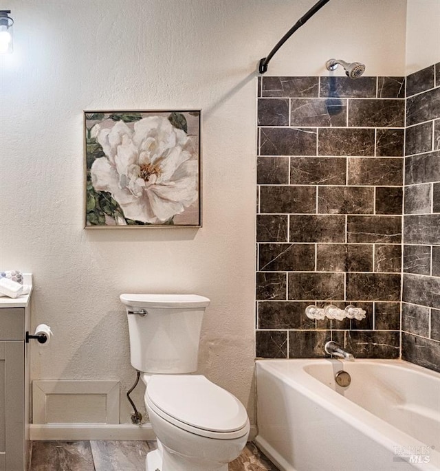 full bathroom with toilet, shower / bath combination, baseboards, and vanity