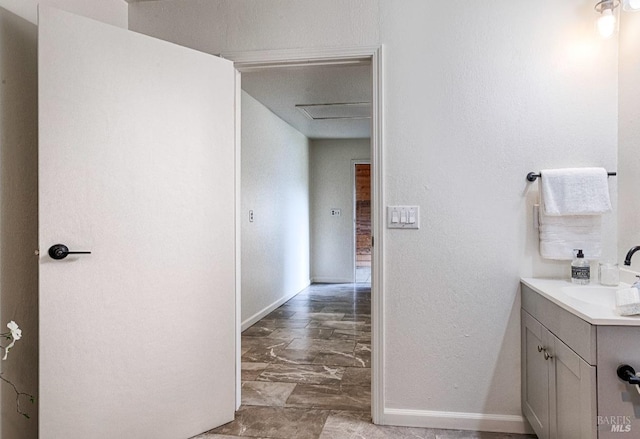 bathroom with baseboards and vanity