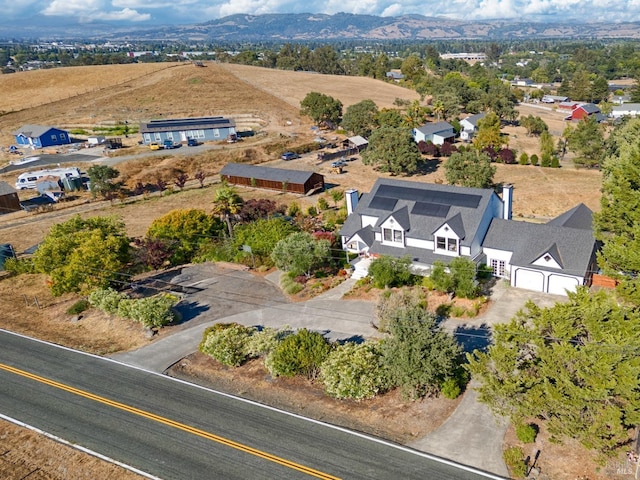 birds eye view of property with a mountain view