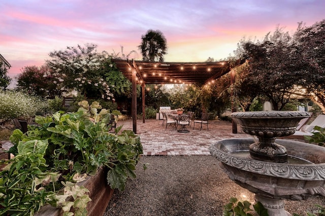 patio terrace at dusk with a pergola