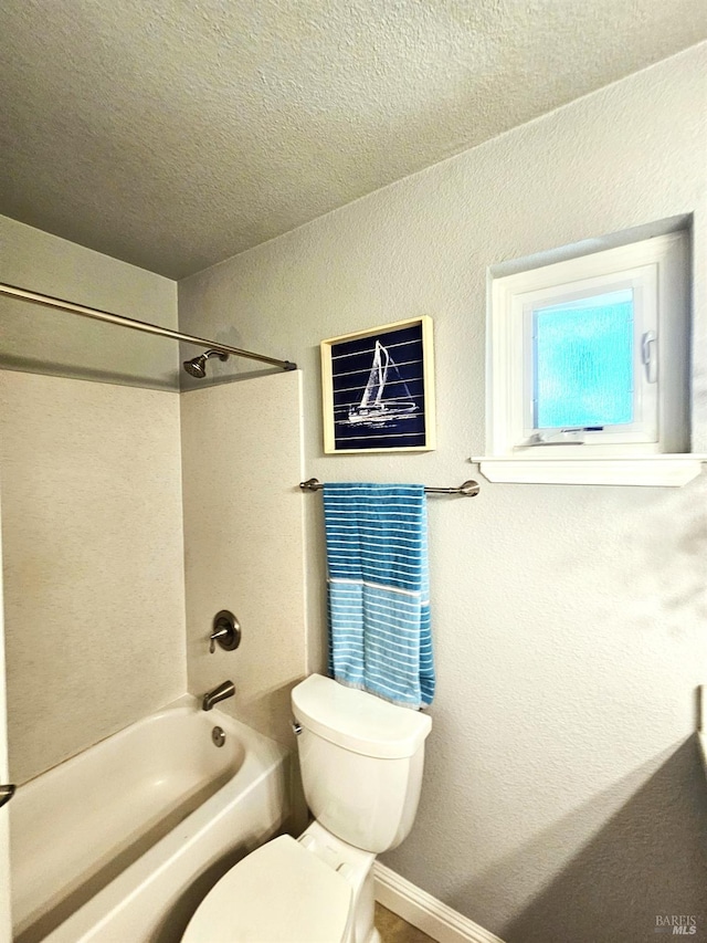 bathroom featuring a textured ceiling, toilet, and shower / bathtub combination