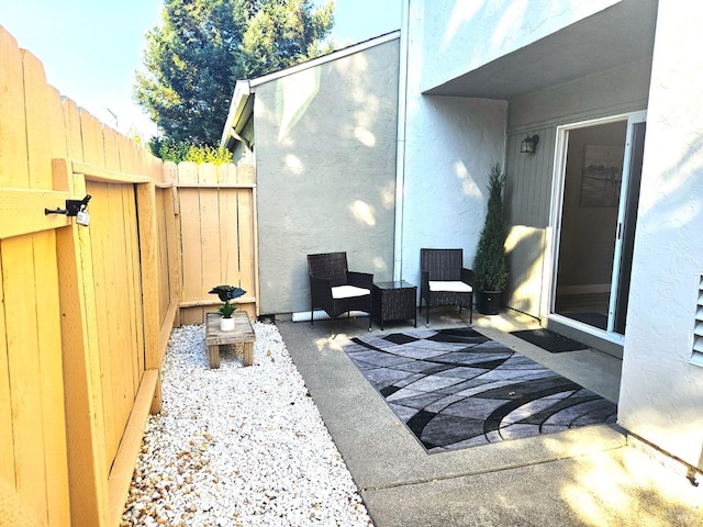 view of patio featuring fence