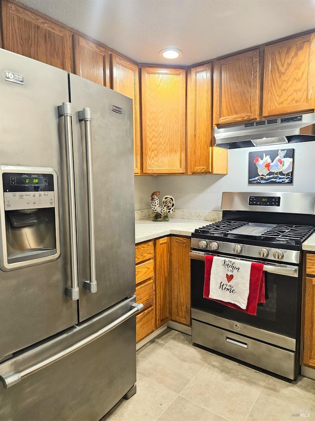 kitchen featuring appliances with stainless steel finishes and light tile patterned floors