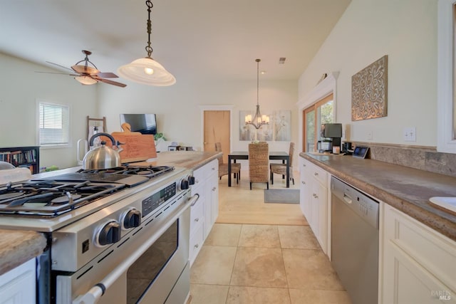 kitchen with white cabinetry, stainless steel appliances, a healthy amount of sunlight, and decorative light fixtures