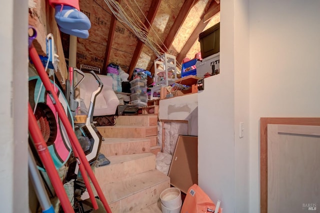 staircase featuring lofted ceiling