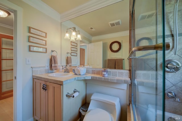 bathroom featuring toilet, vanity, tile patterned flooring, and crown molding