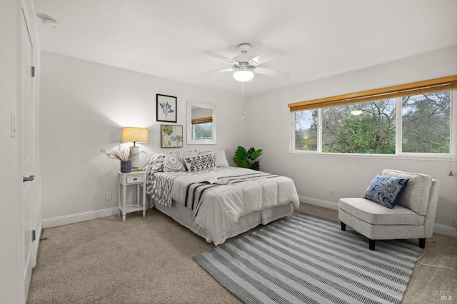 bedroom featuring ceiling fan and light carpet