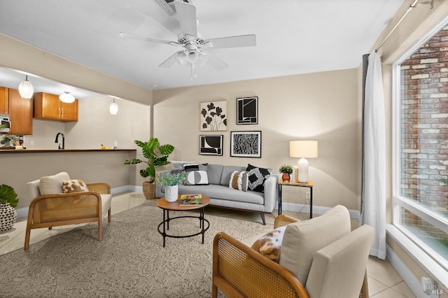 living room with sink, ceiling fan, and light tile patterned flooring