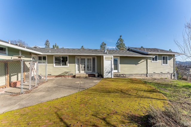 back of property featuring a lawn, french doors, and a patio area