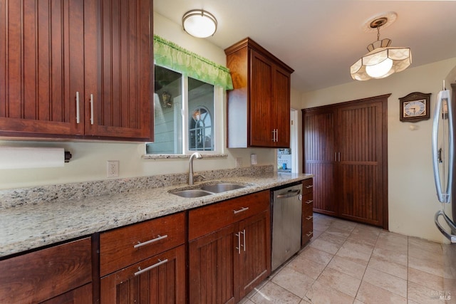 kitchen featuring dishwasher, light stone counters, decorative light fixtures, light tile patterned floors, and sink