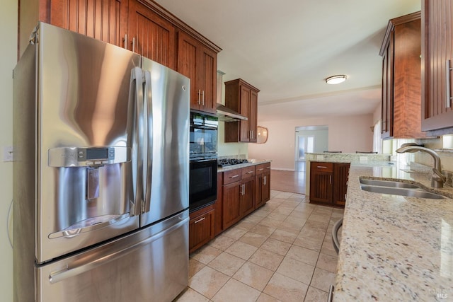 kitchen featuring light tile patterned floors, sink, light stone countertops, and stainless steel refrigerator with ice dispenser