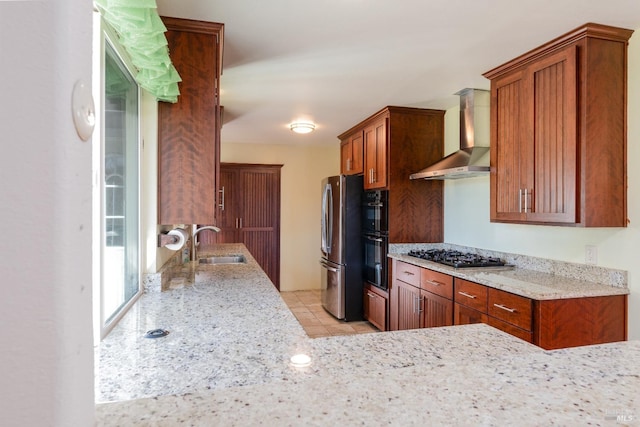 kitchen featuring black appliances, light stone countertops, sink, light tile patterned floors, and wall chimney exhaust hood