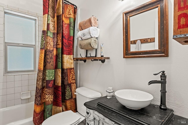 bathroom with shower / bath combo, plenty of natural light, vanity, and toilet