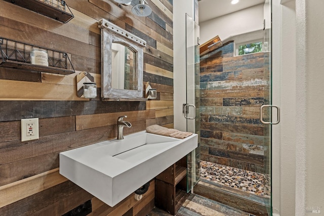 bathroom with wood walls and a shower with door