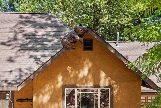 exterior space with a shingled roof