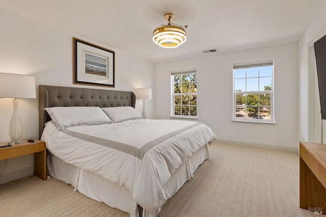 bedroom featuring light colored carpet