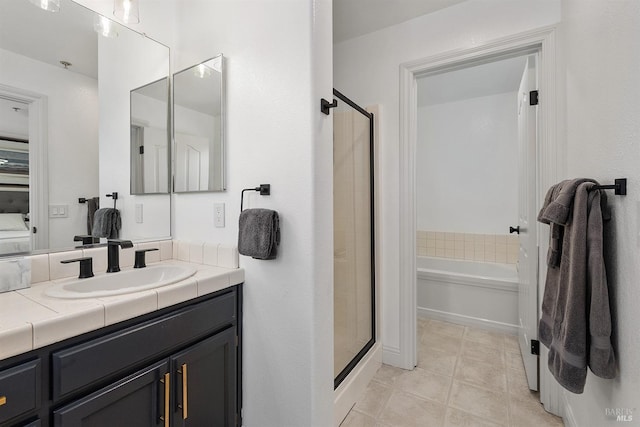 bathroom with tile patterned flooring, vanity, and plus walk in shower