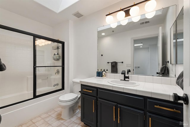 full bathroom with vanity, toilet, tile patterned floors, and enclosed tub / shower combo