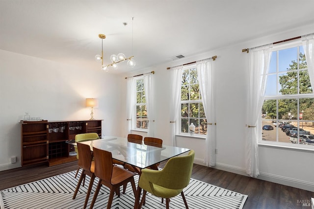 dining room with an inviting chandelier and dark hardwood / wood-style floors