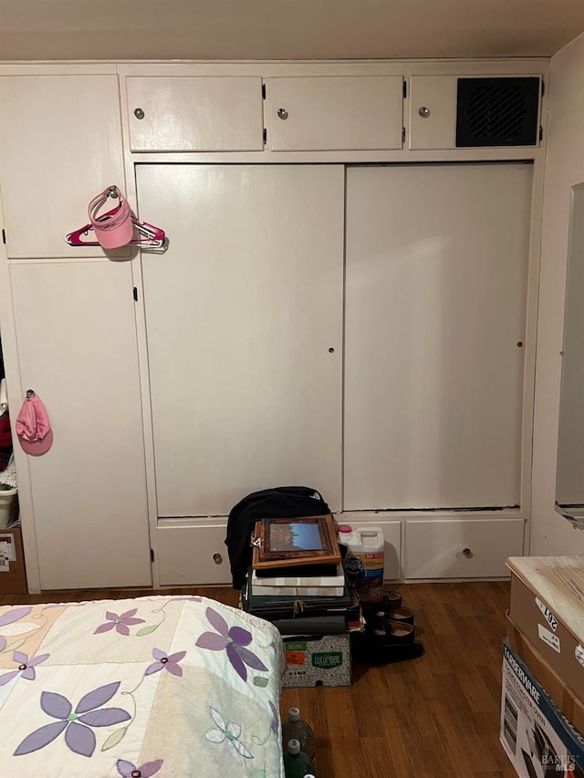 unfurnished bedroom featuring a closet and dark hardwood / wood-style floors