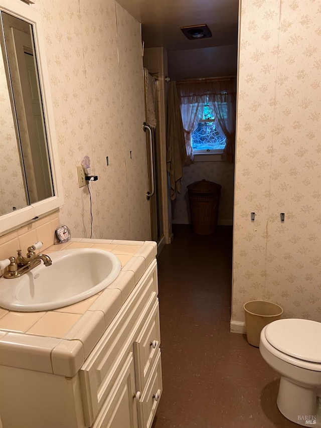 bathroom featuring vanity and toilet