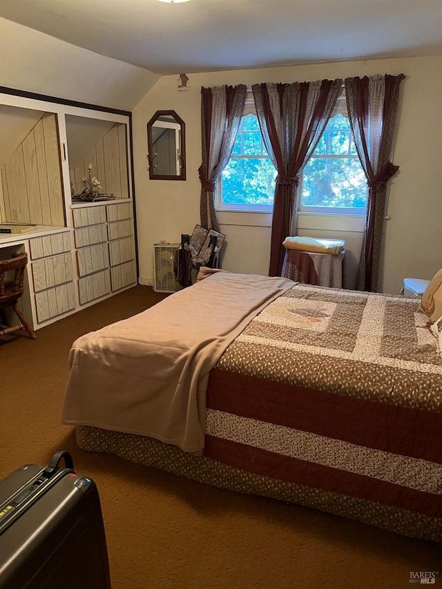 bedroom featuring vaulted ceiling and carpet flooring