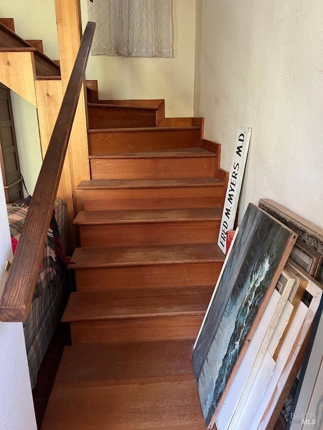 stairs featuring wood-type flooring